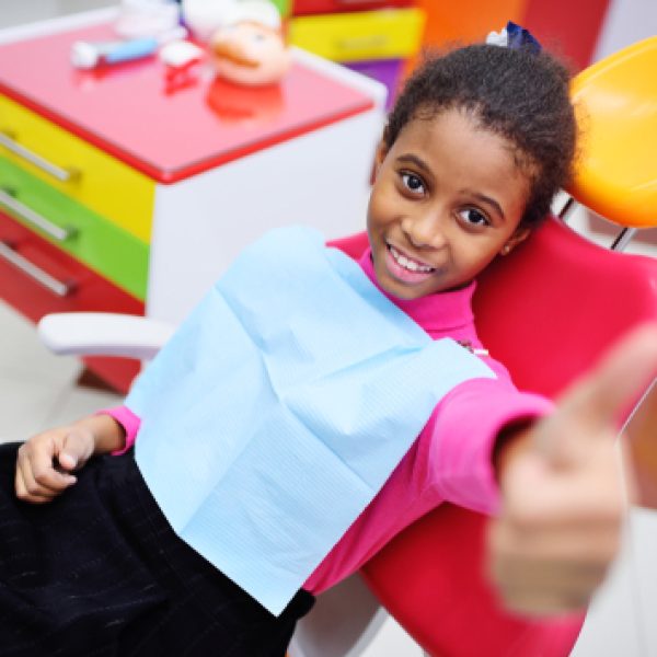 African,American,Baby,Girl,Smiling,Sitting,In,A,Dental,Chair
