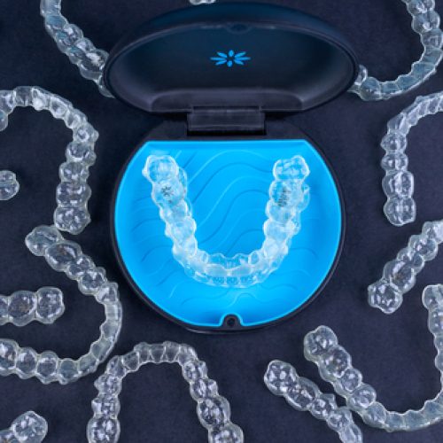 Plastic,Case,With,Invisible,Transparent,Orthodontic,Retainers,Invisalign,On,Black